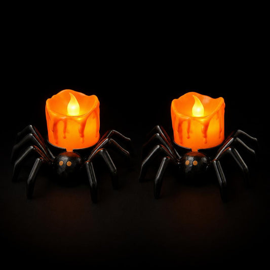 Set of two black spider LED candles glowing orange, on black