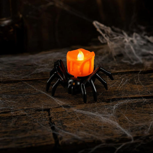 Black spider LED candle on an old wooden table with cobwebs