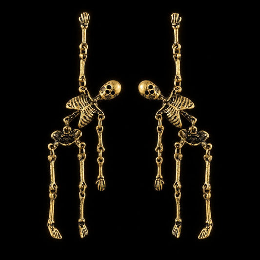 Skeleton dangle earrings in antiqued gold, shown as a pair on black