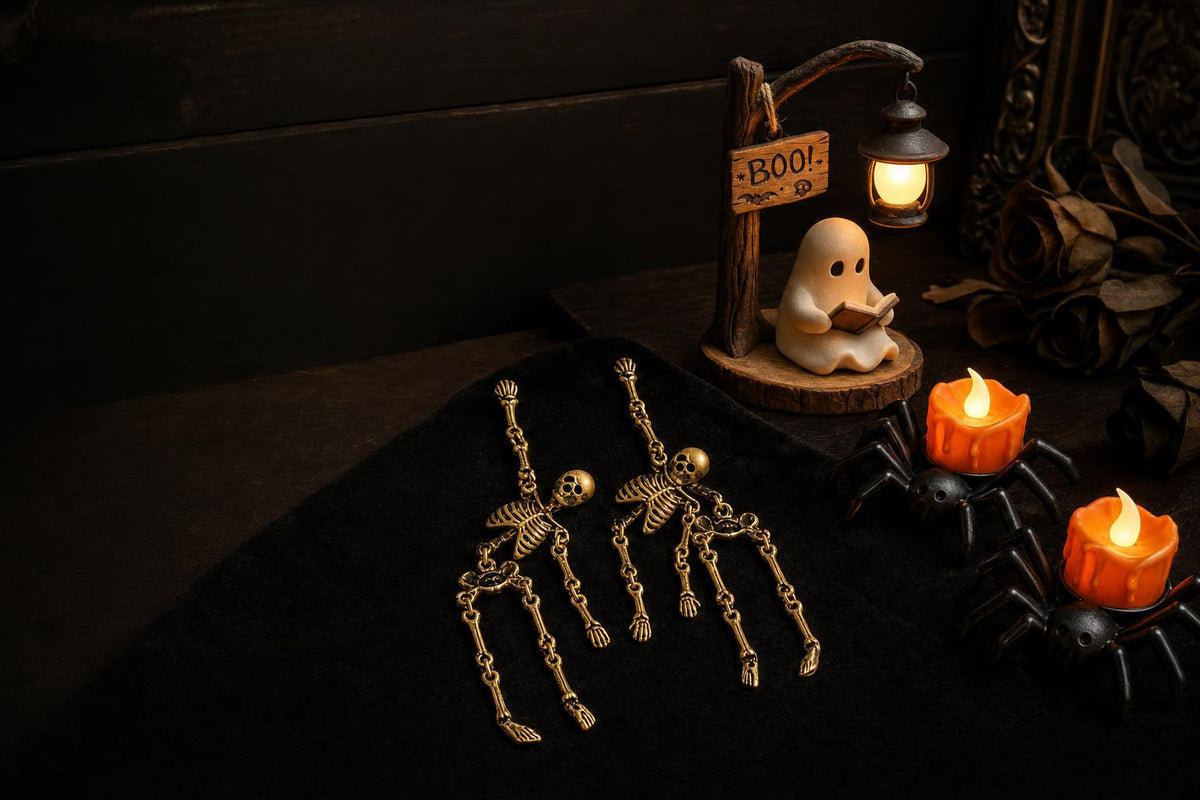 Skeleton earrings, ghost night light and spider LED candles on black velvet — The Halloween Edition