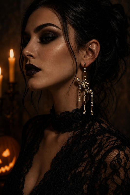 Model wearing the skeleton dangle earrings in antiqued gold